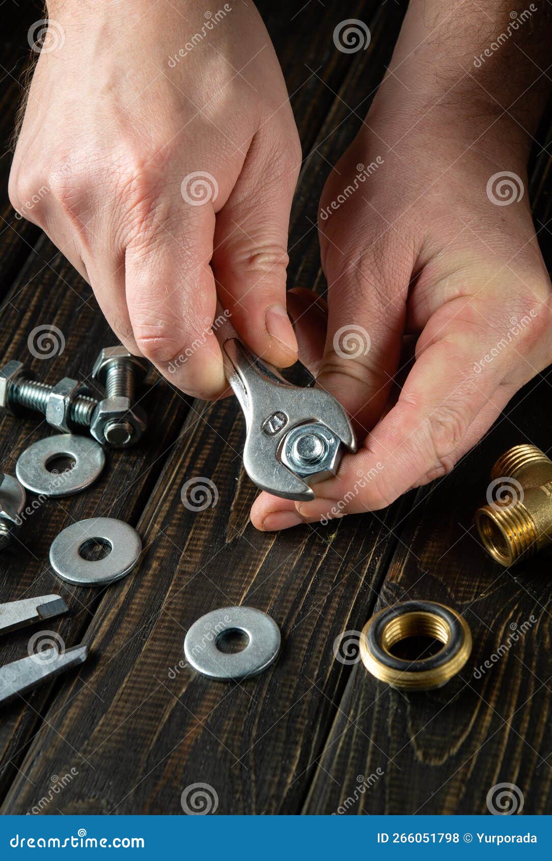 The Master Tightens the Nut with a Wrench on the Bolt. Work Environment