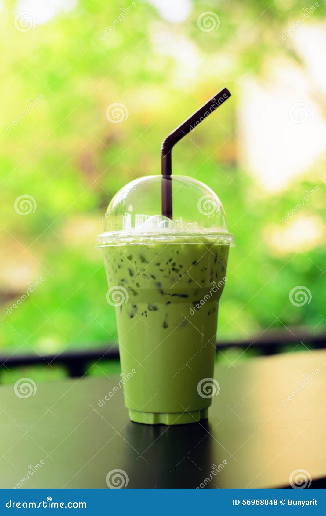 matcha green tea latte clod on wooden table background