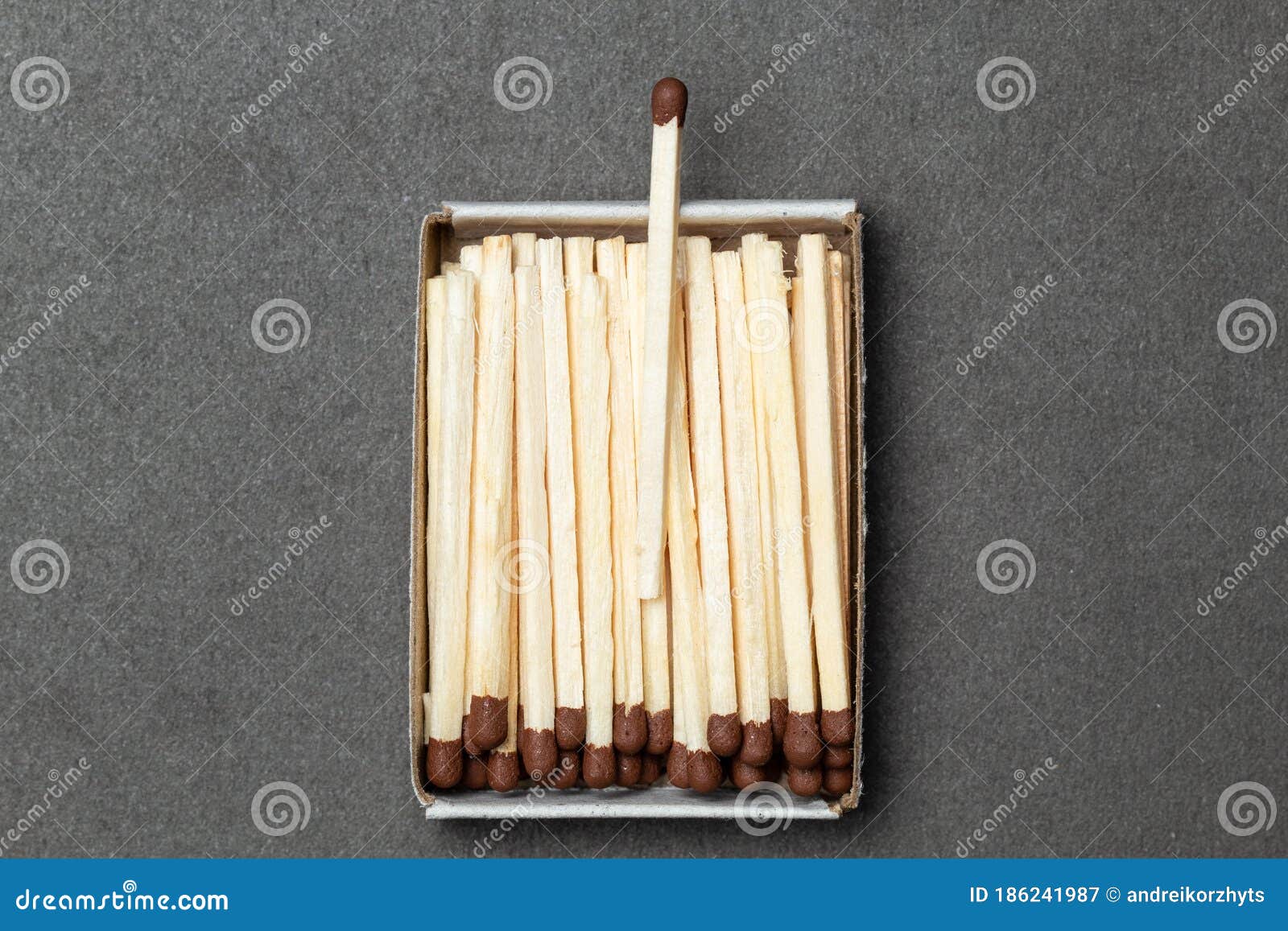 matchbox is over gray background, one match is above other ones