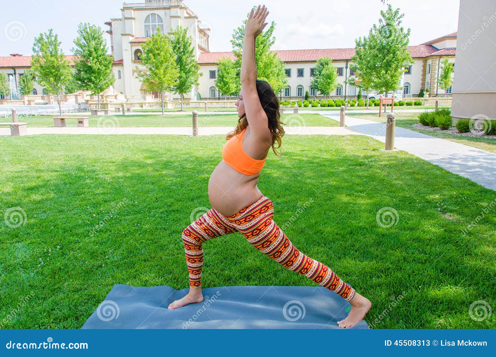 Maternity Yoga exercise healthy life style. Woman doing yoga exercises while pregnant in last trimester bending and stretching on her yoga mat.