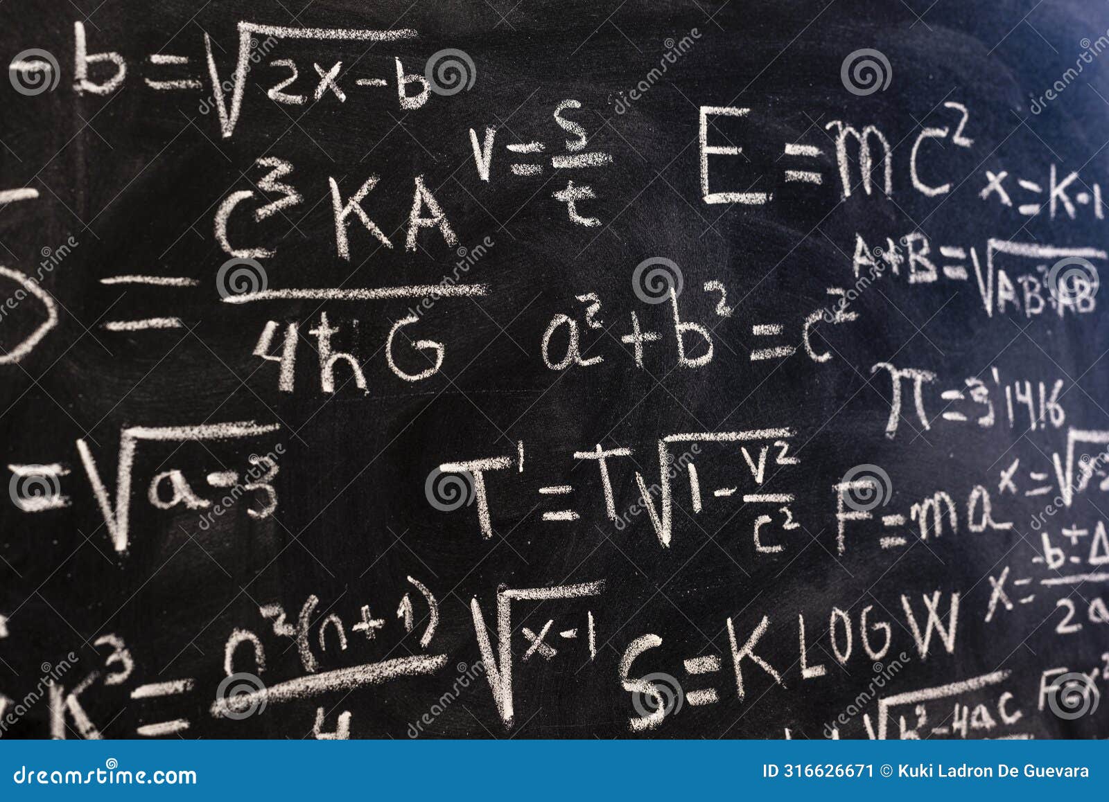 mathematical equations and physics formulas handwritten on blackboard