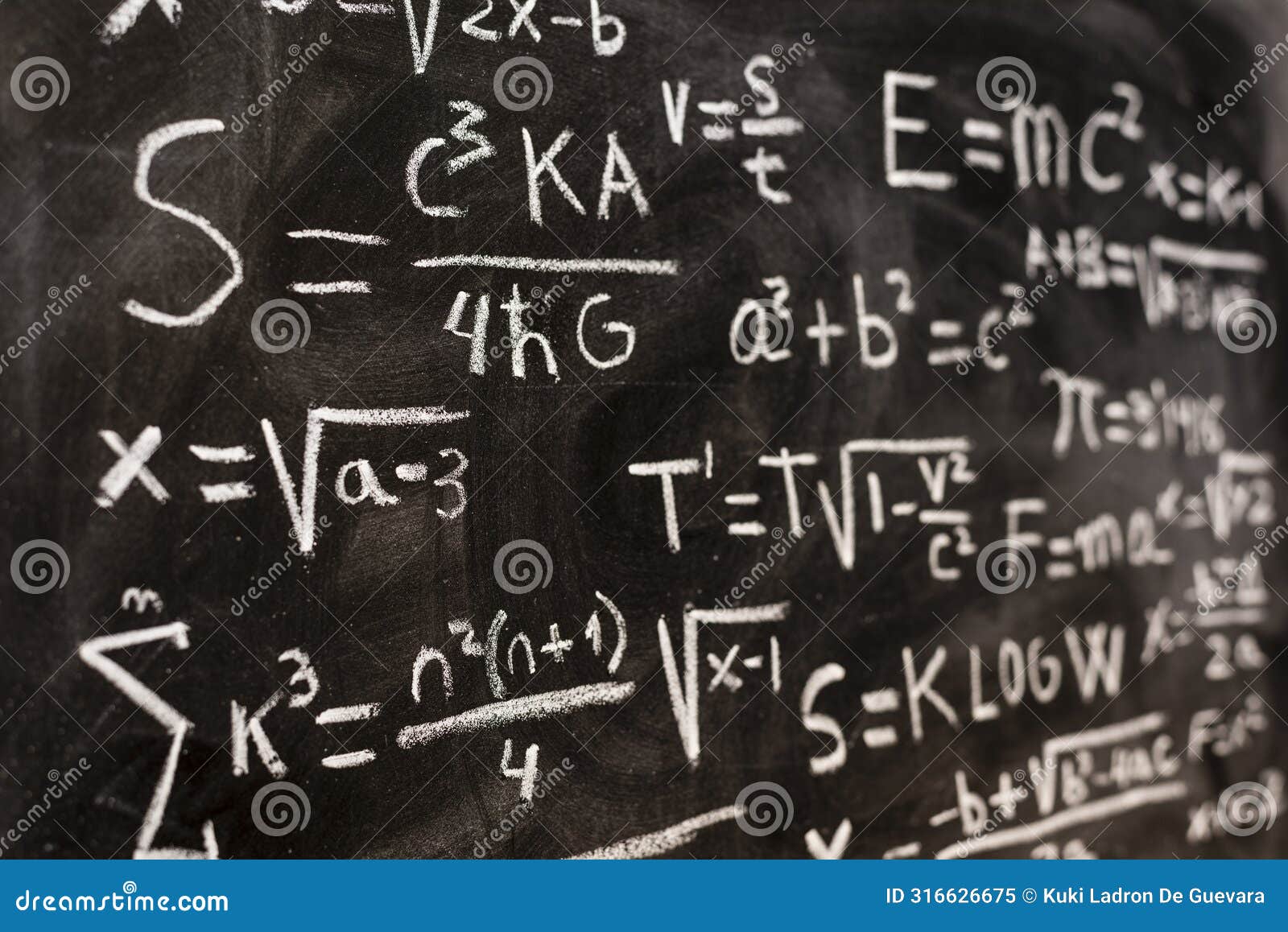 mathematical equations and physics formulas handwritten on blackboard
