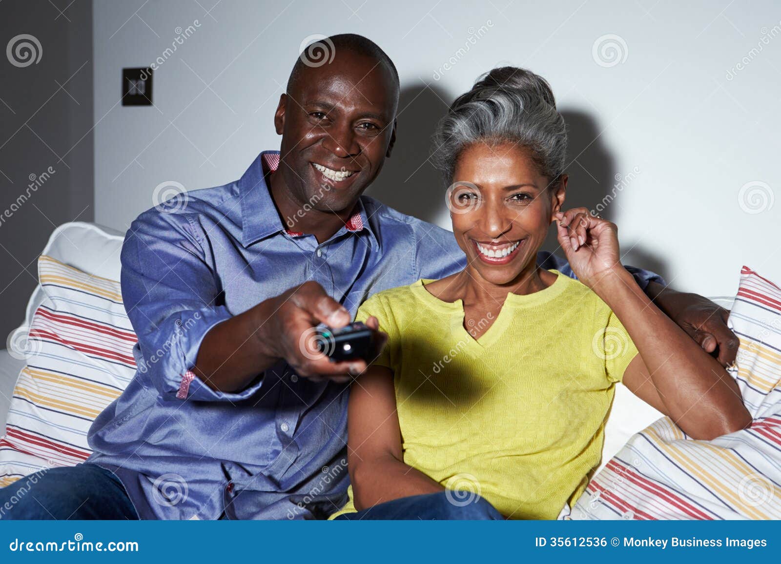 Mature African American Couple On Sofa Watching Tv