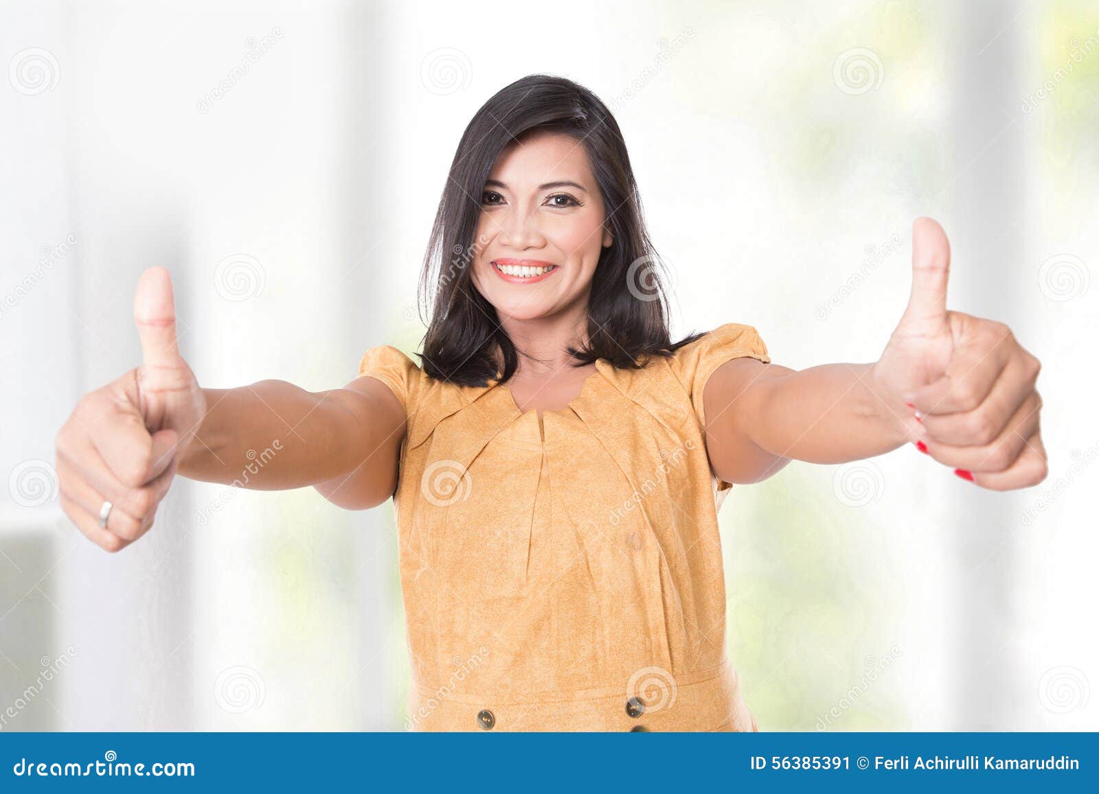 Mature Asian Woman Posing at the Camera Showing Two Thumbs U picture