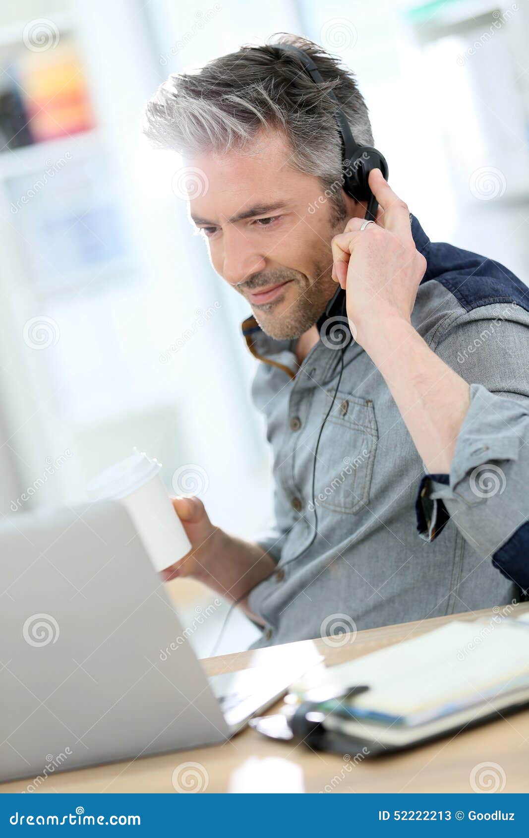 mature businessman teleworking on laptop