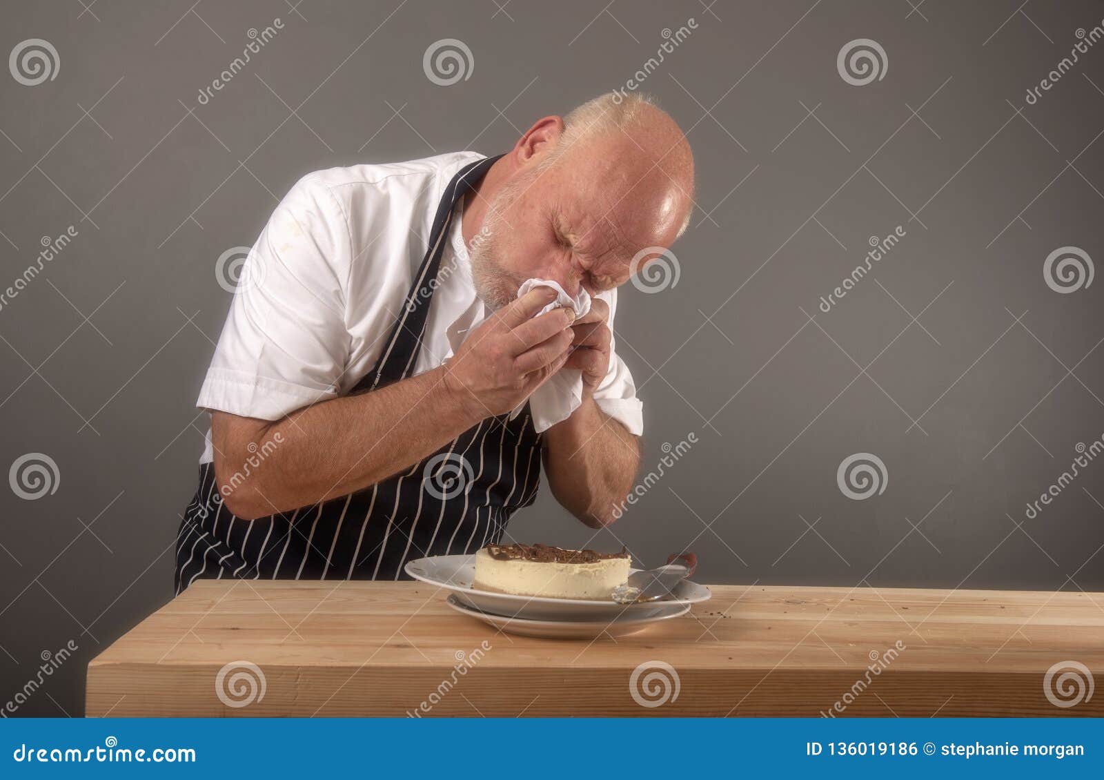 mature-chef-sneezing-over-food-ingredients-kitchen-setting-mature-chef-sneezing-over-food-ingredients-136019186.jpg