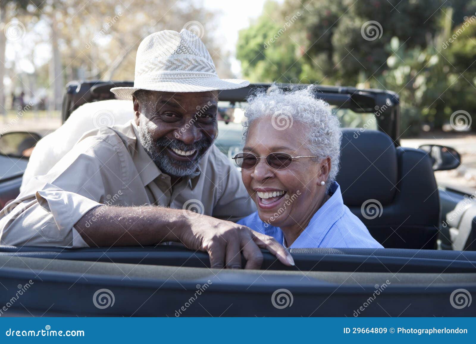 mature couple at the back seat of car smiling