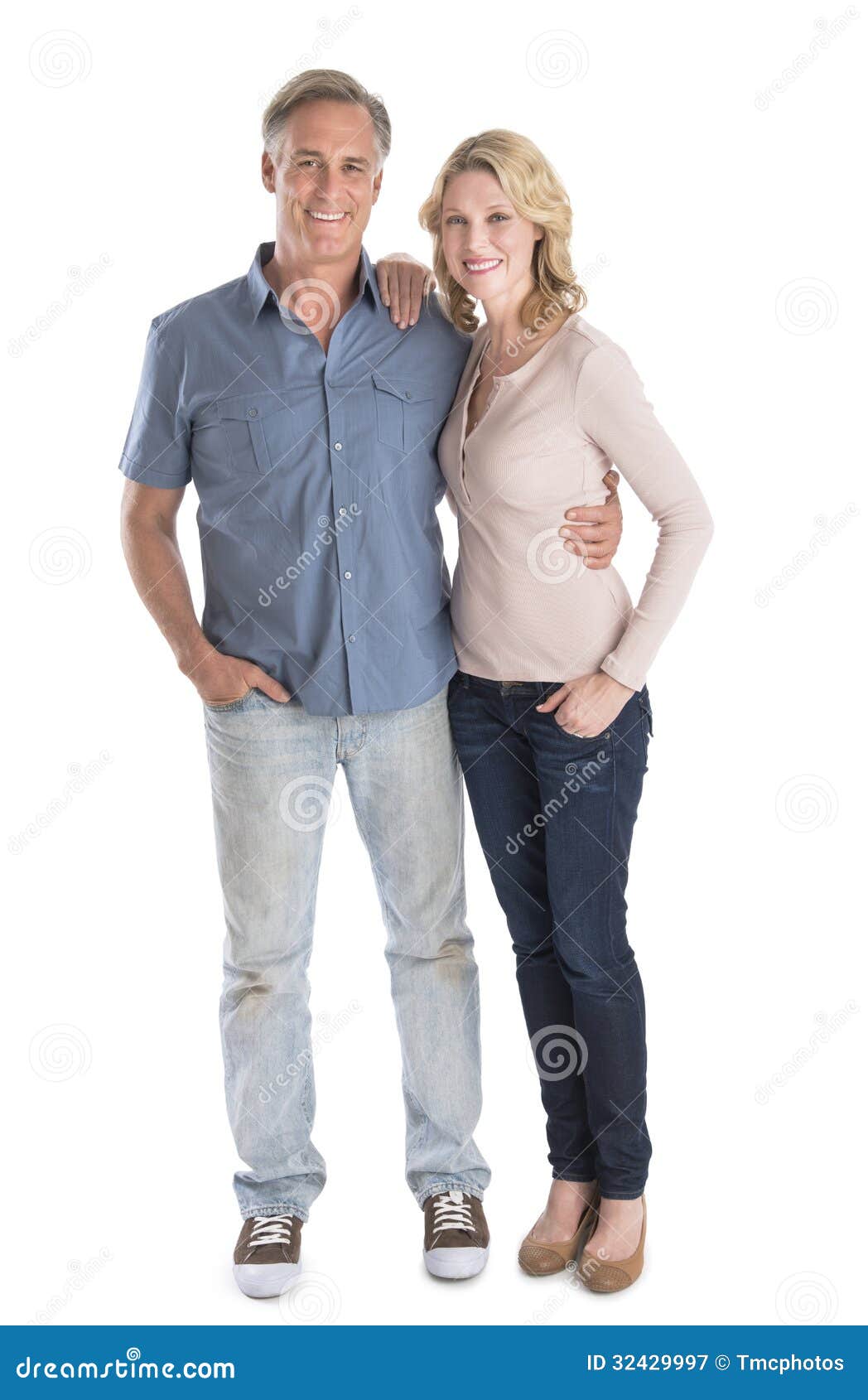mature couple standing with hands in pockets