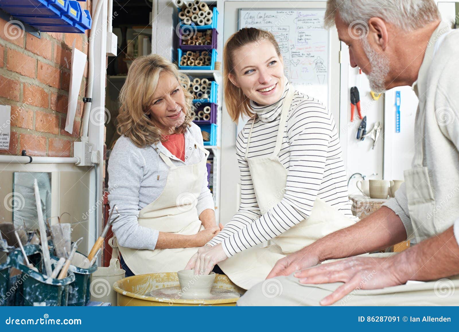 Mature Couple with Teacher in Pottery Class Stock Image Image of