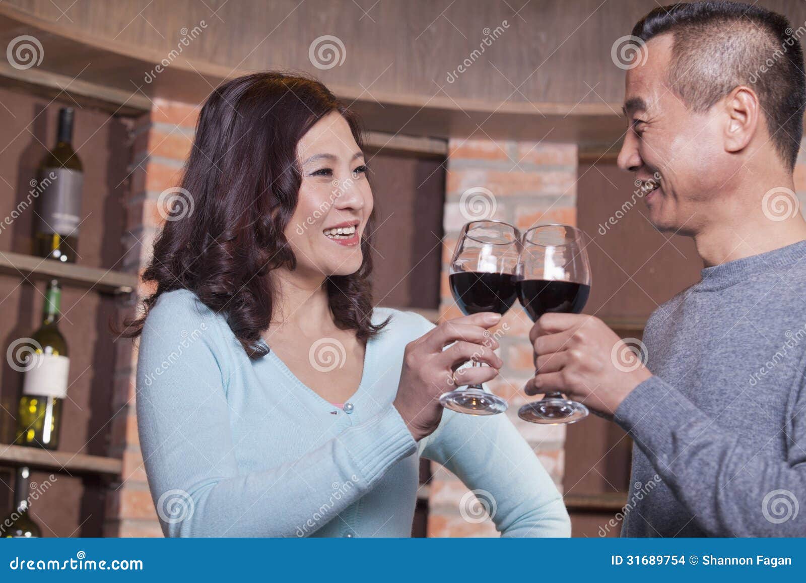 mature couple at a winetasting, toasting