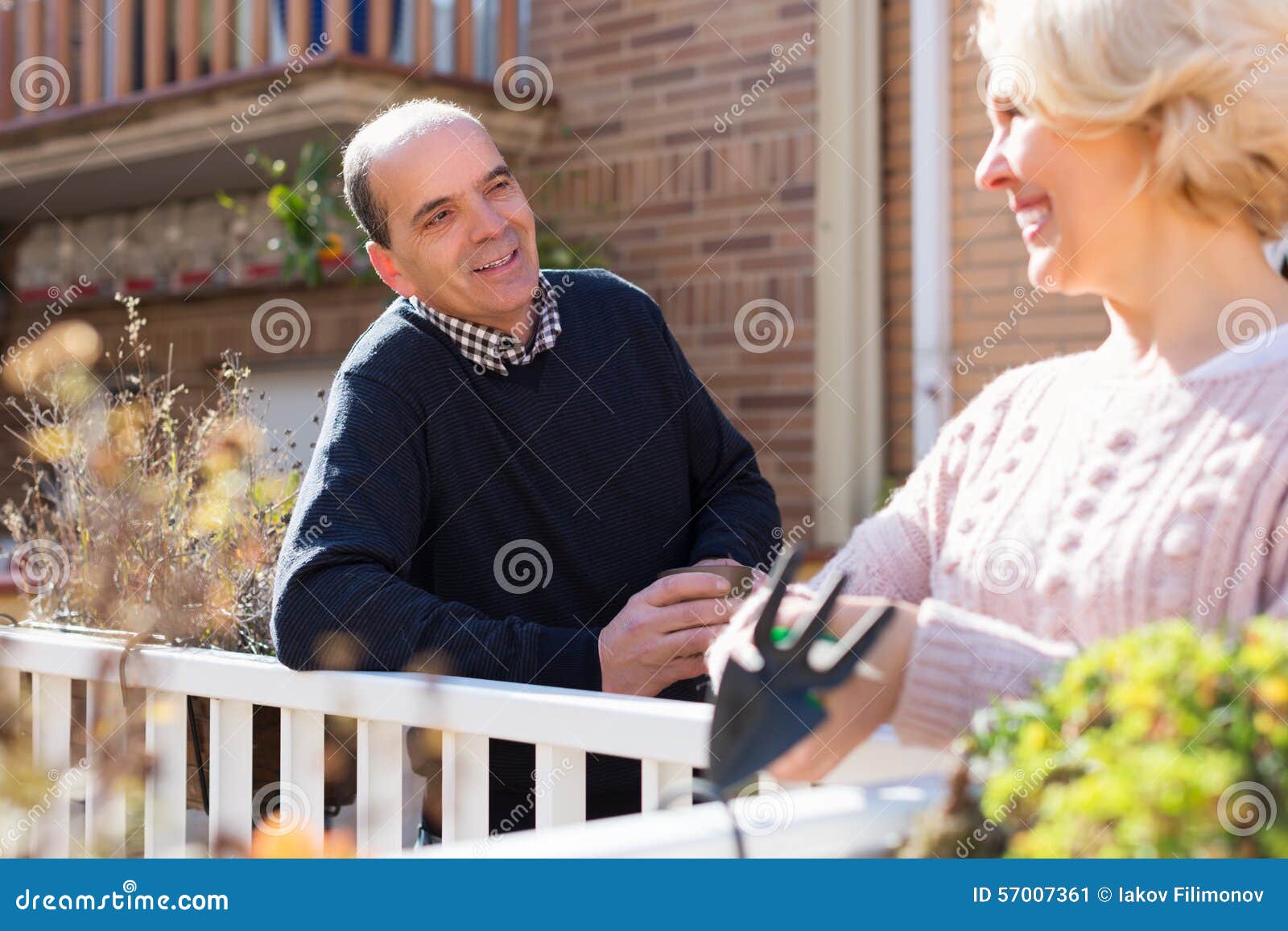 mature cuople talking at balcon