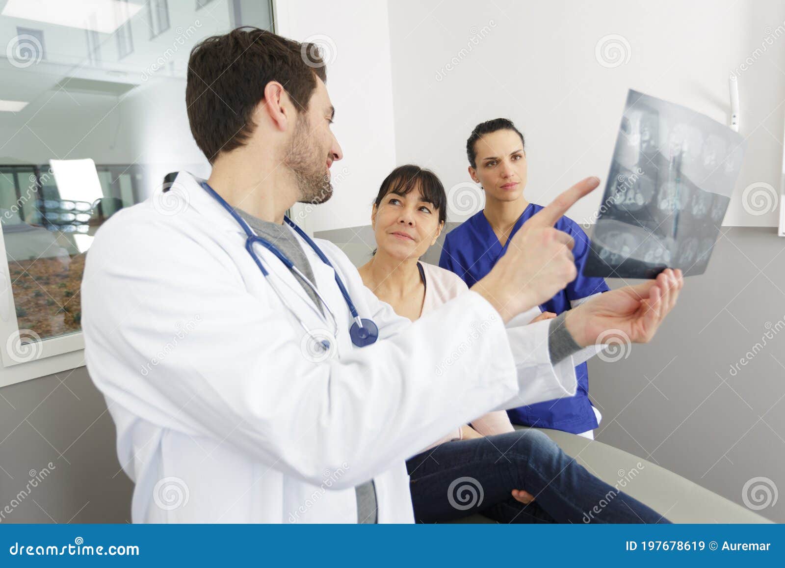 mature doctor in office looking at xray results