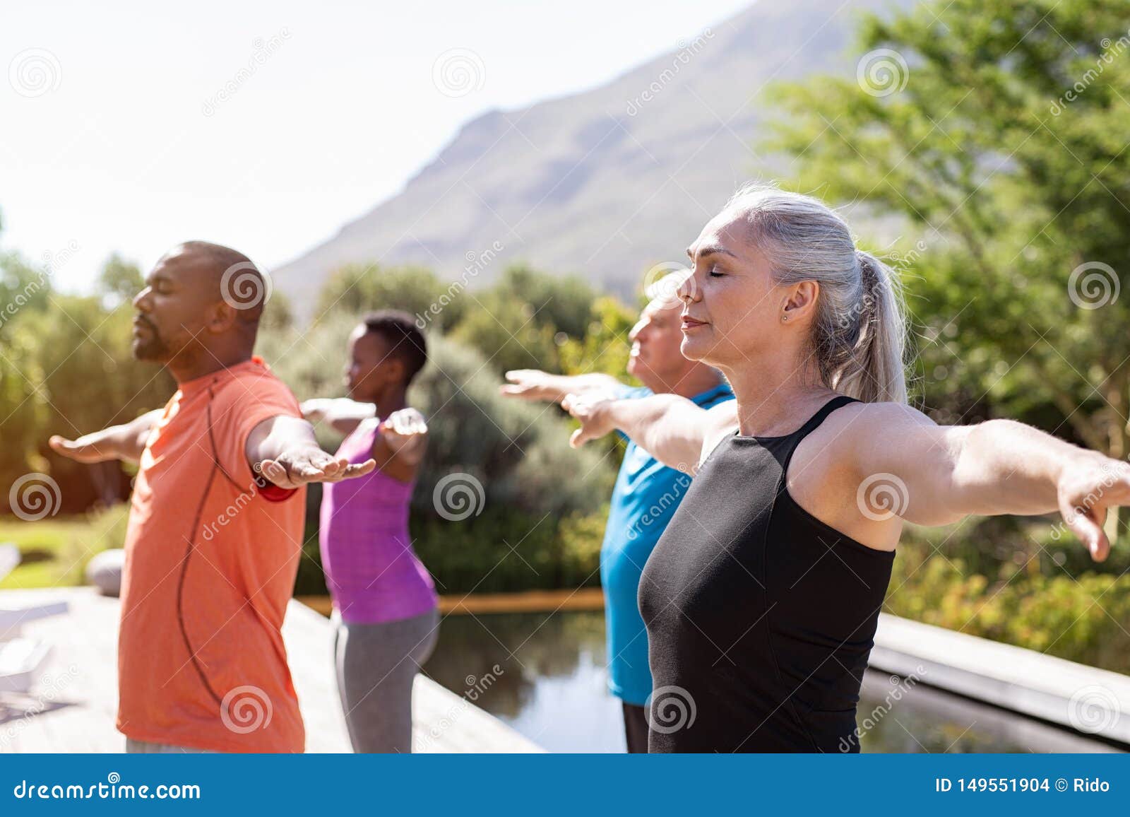mature group of people doing breathing exercise