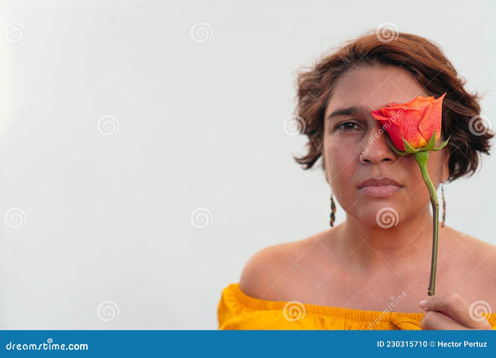 Mature Latina Woman with an Orange Flower Looking at the Camera Stock Photo  - Image of hispanic, mature: 230315710