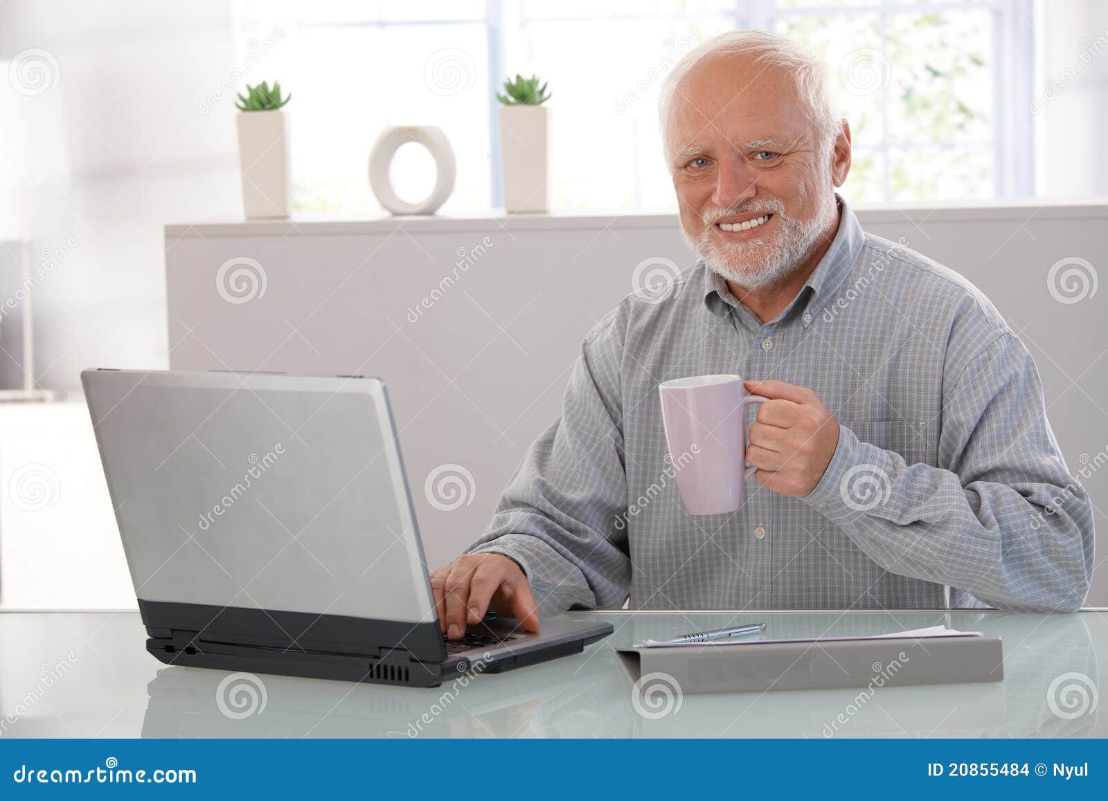 mature man with computer smiling