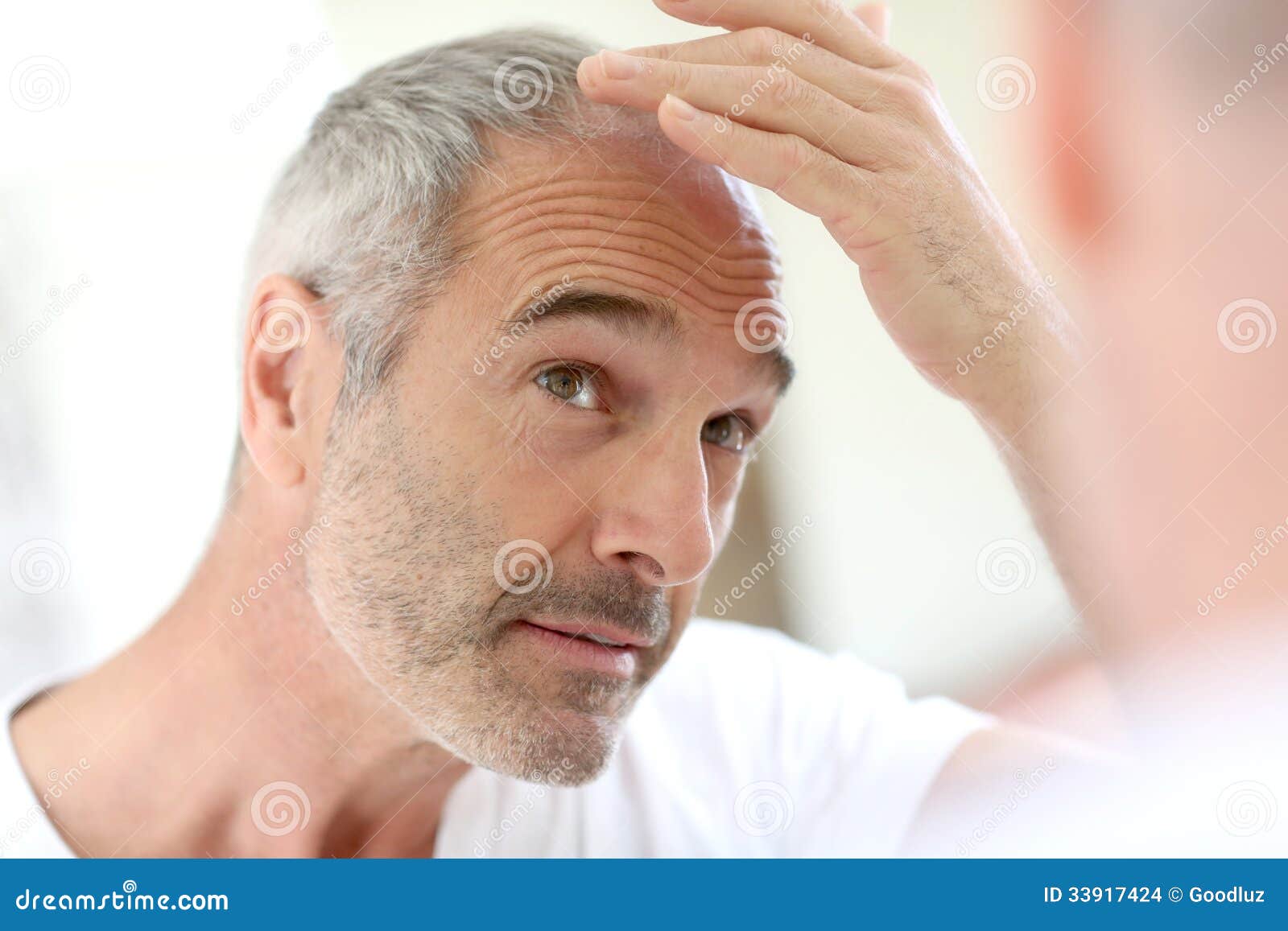 mature man looking at hair loss