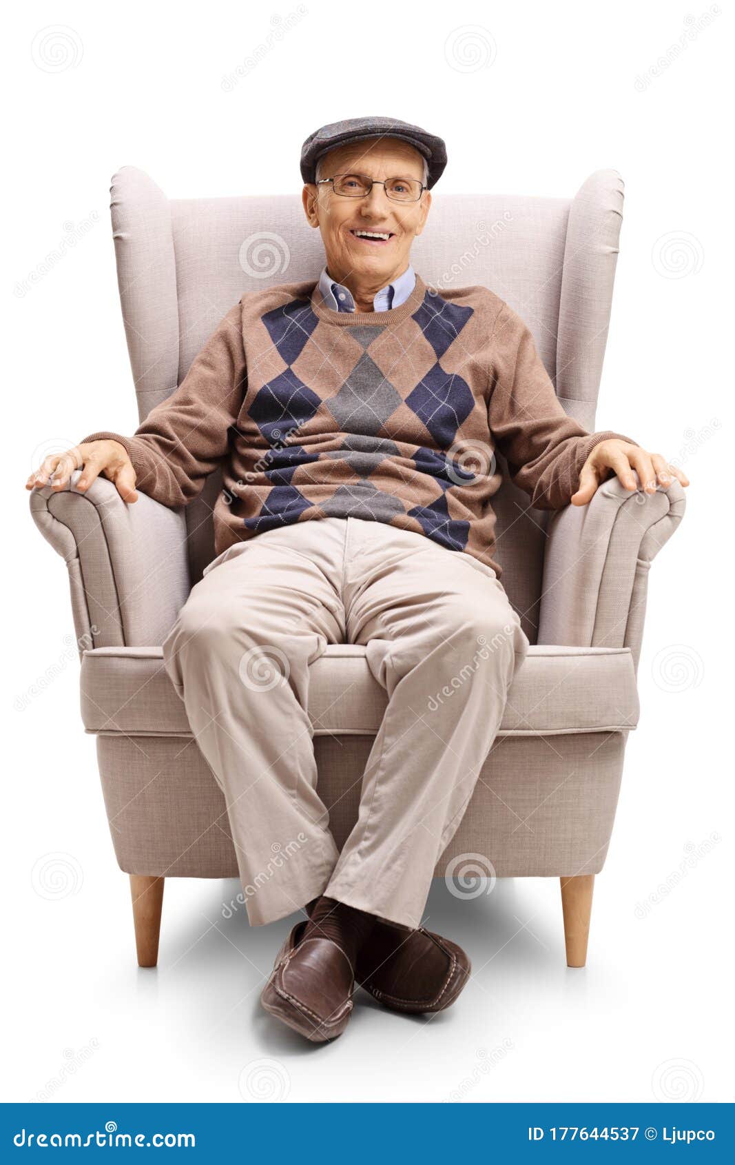Mature Man Sitting In An Armchair And Smiling At The Camera Stock Image