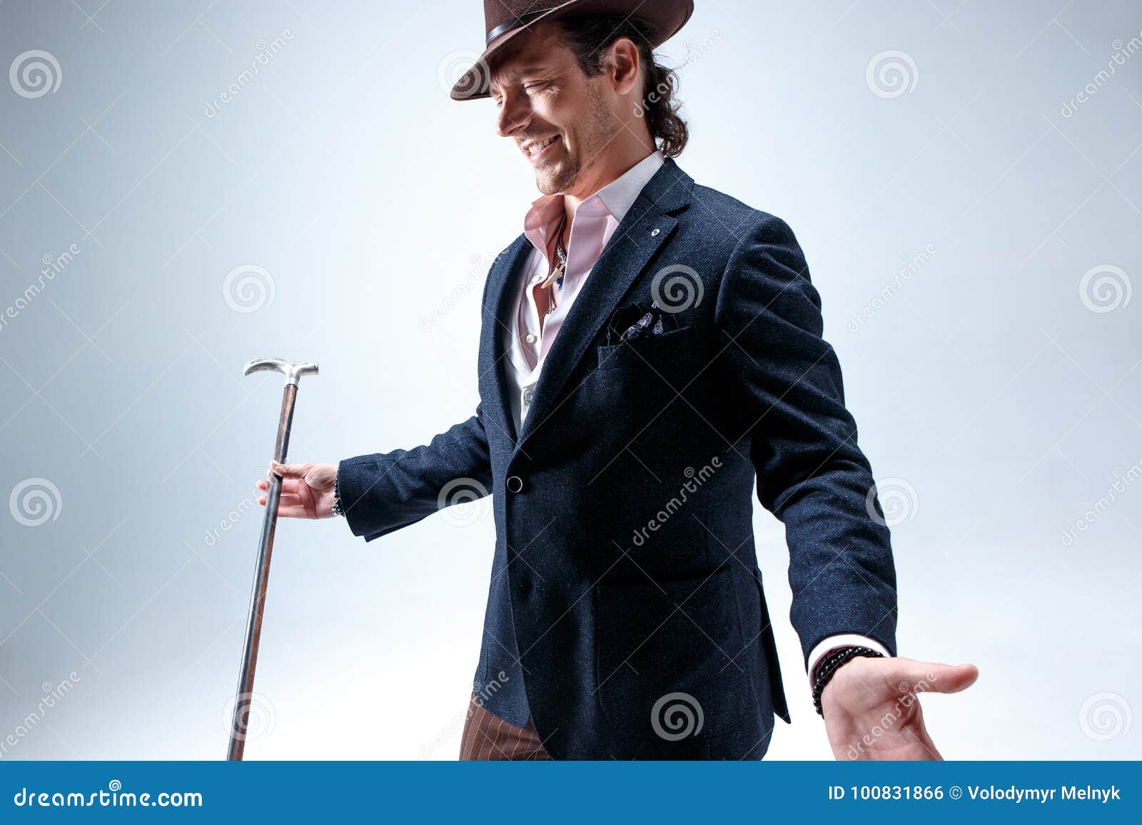 The Mature Man in a Suit and Hat Holding Cane. Stock Photo Image of