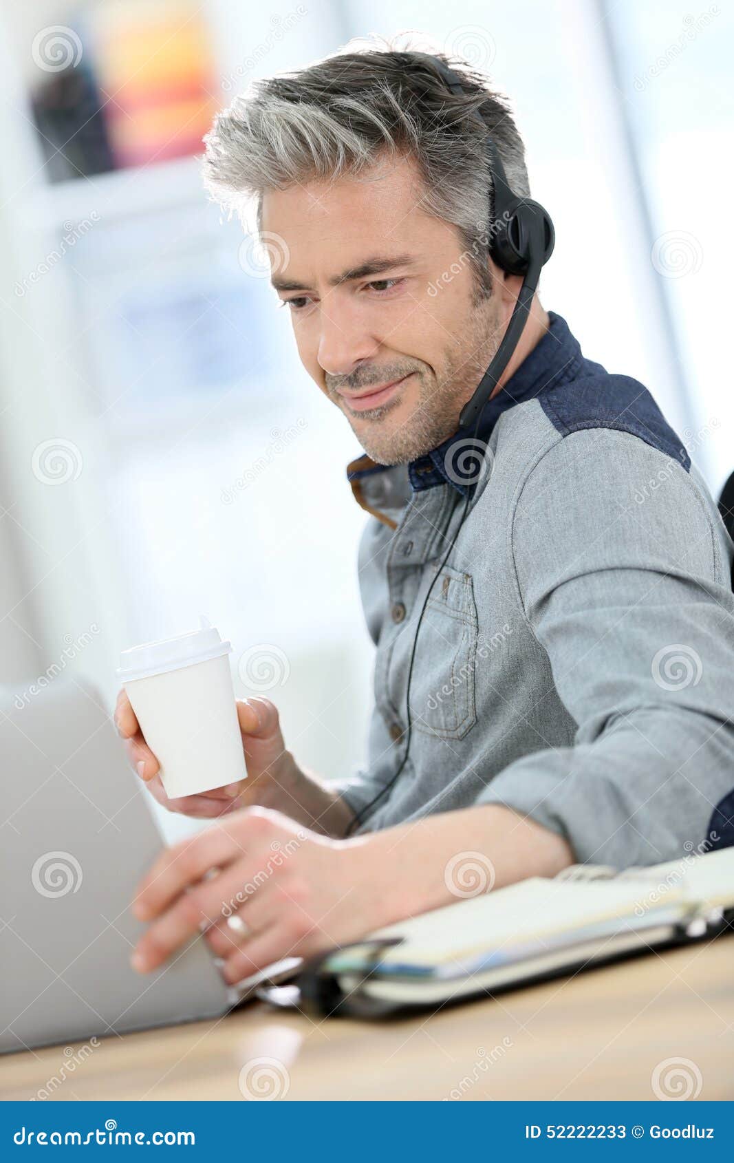 mature man teleworking and drinking coffee
