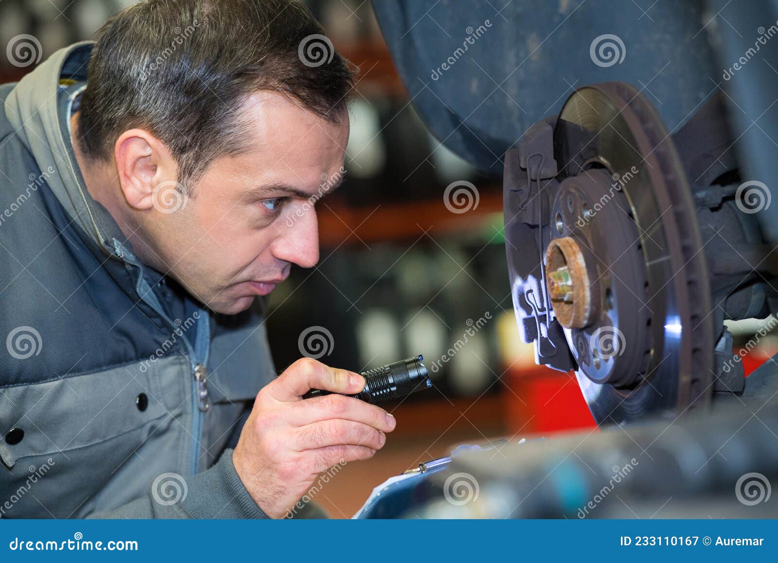 Mature Mechanic Looking at Flywheel with Torch Stock Image Image of