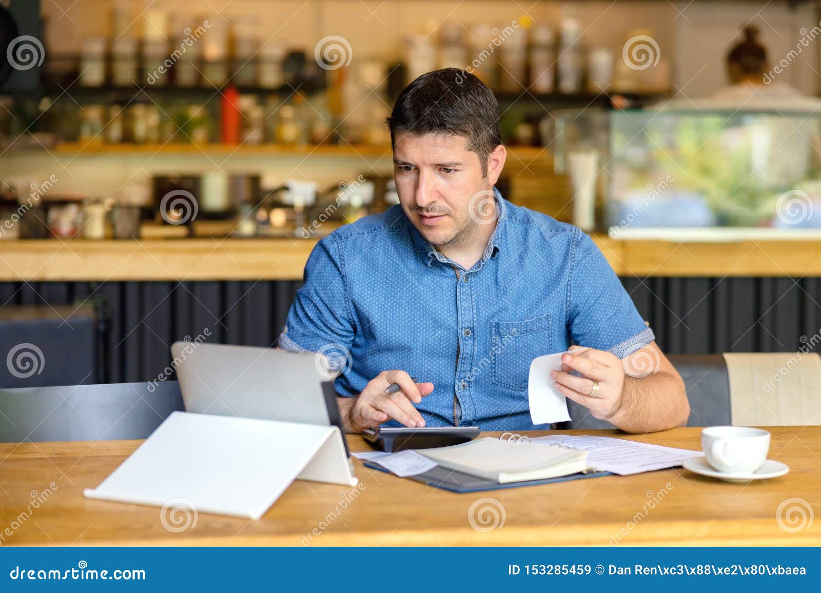 mature small business owner calculating finance bills of activity, entrepreneur using laptop and calculator to work