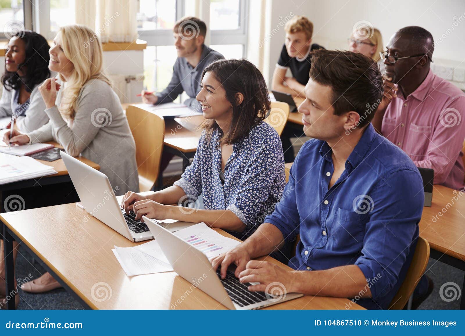 mature students sitting at desks in adult education class