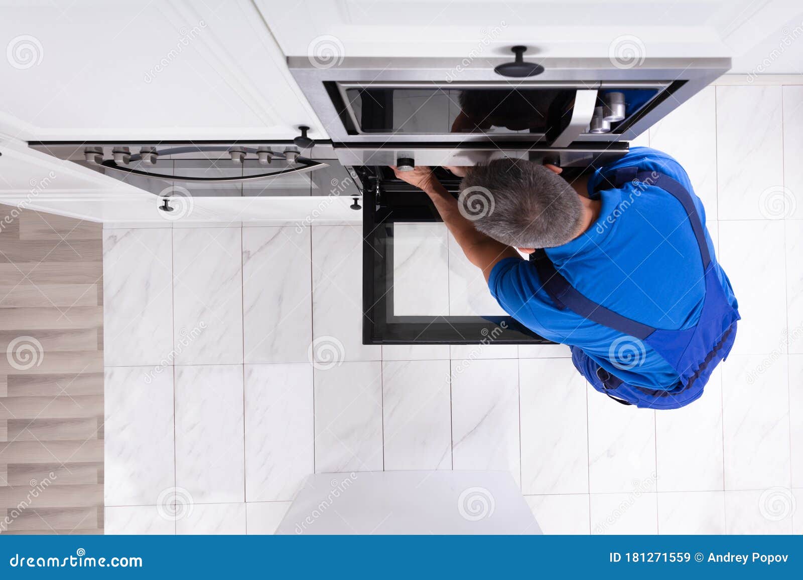 Technician Repairing Oven stock image. Image of oven 181271559