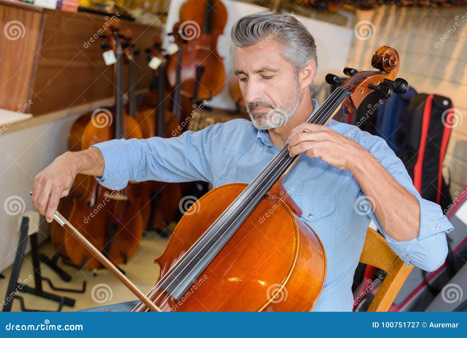 Mature Violin Maker while Testing Violins in Laboratory Stock Image
