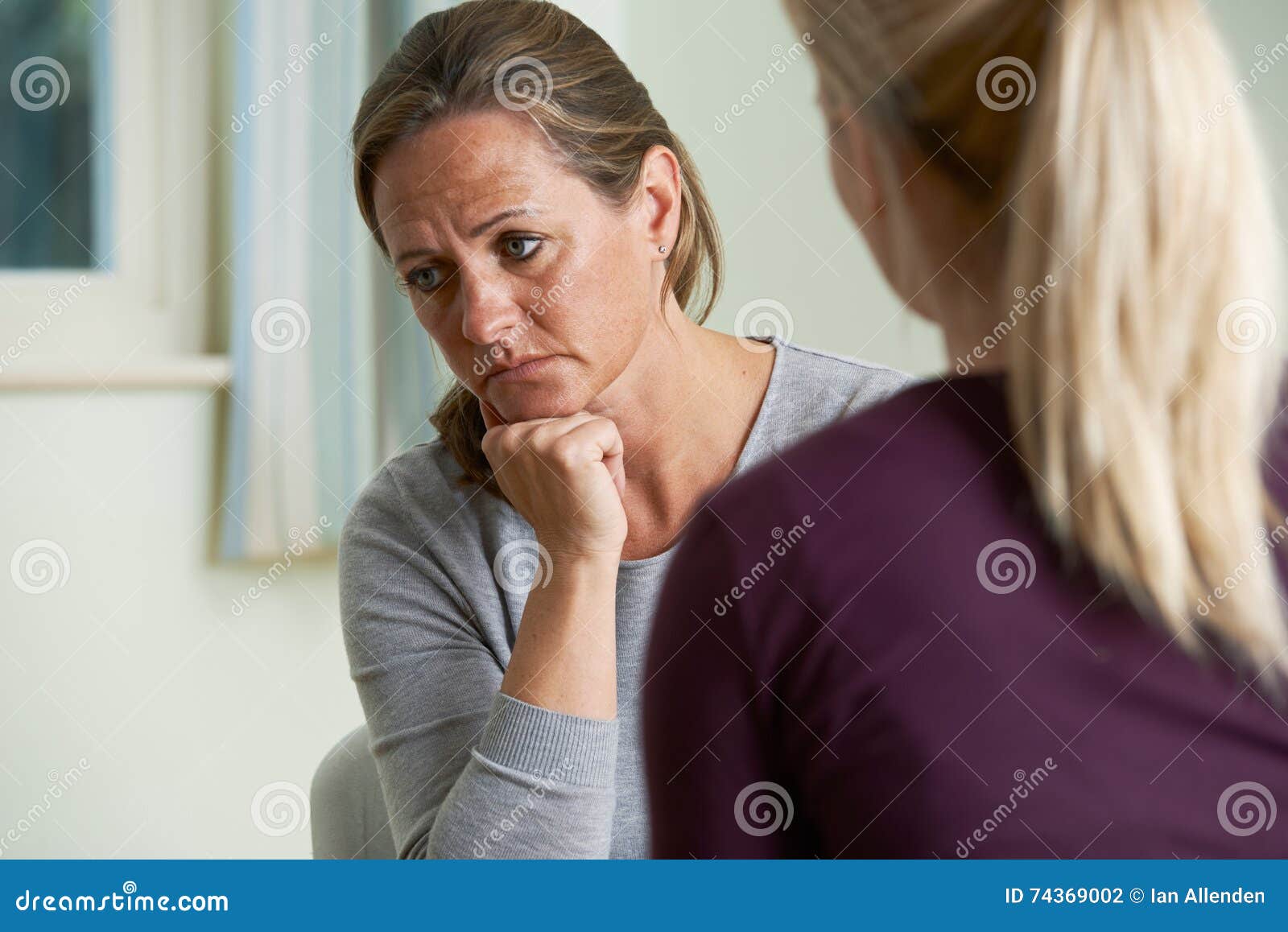 mature woman discussing problems with counselor