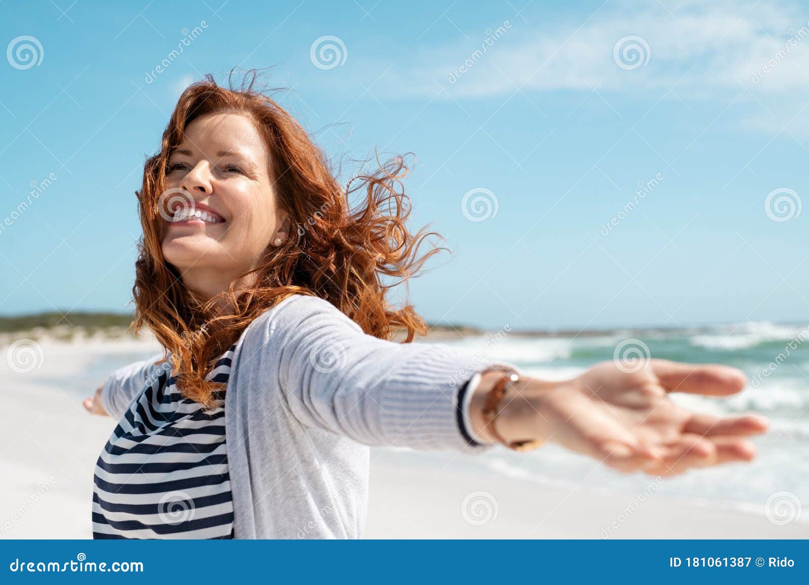 mature woman enjoy breeze at beach