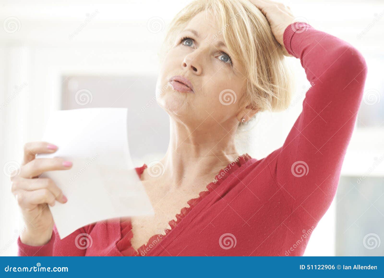 mature woman experiencing hot flush from menopause