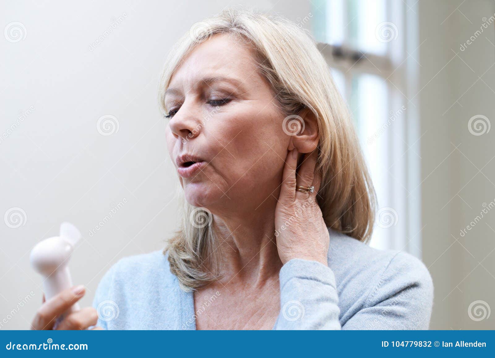 mature woman experiencing hot flush from menopause