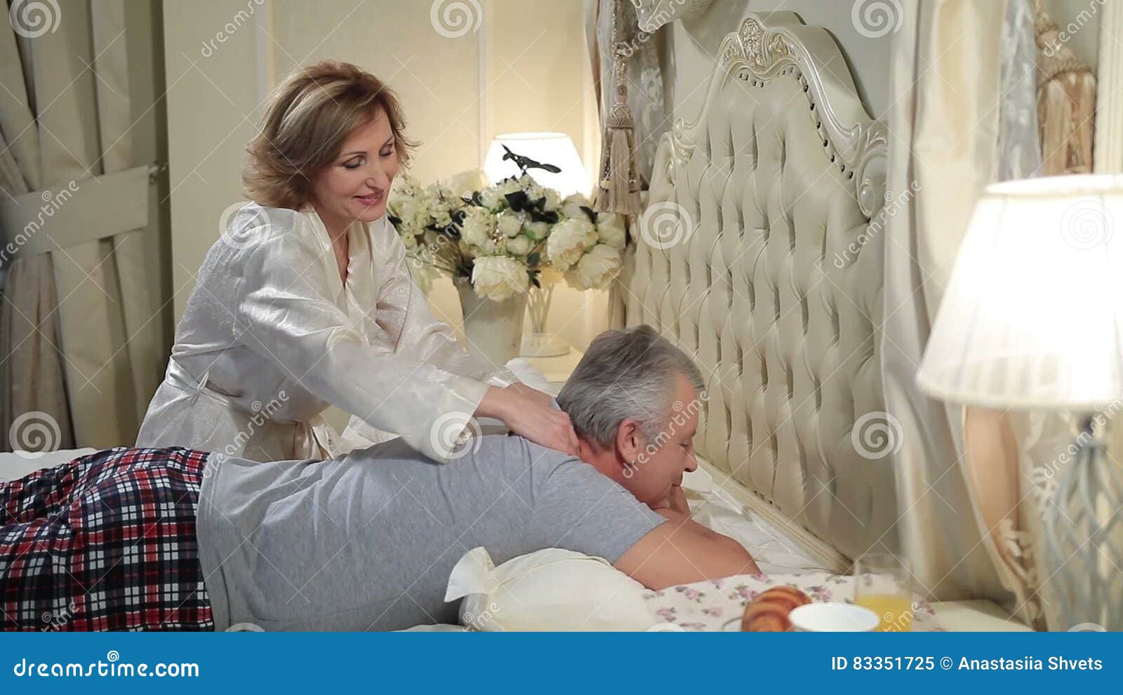 Mature Woman Giving Massage To Senior Man in Bed Stock Video