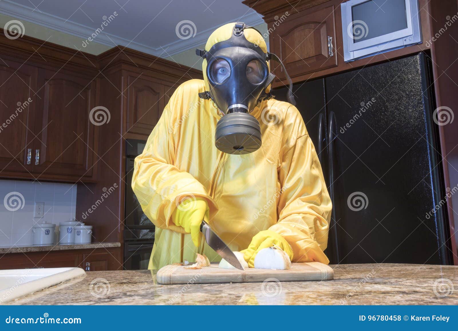 mature woman in haz mat suit chopping onions