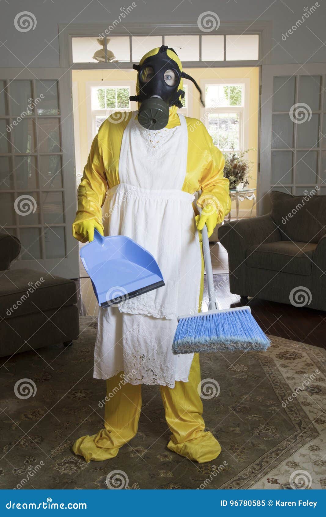 mature woman in haz mat suit in living room with broom