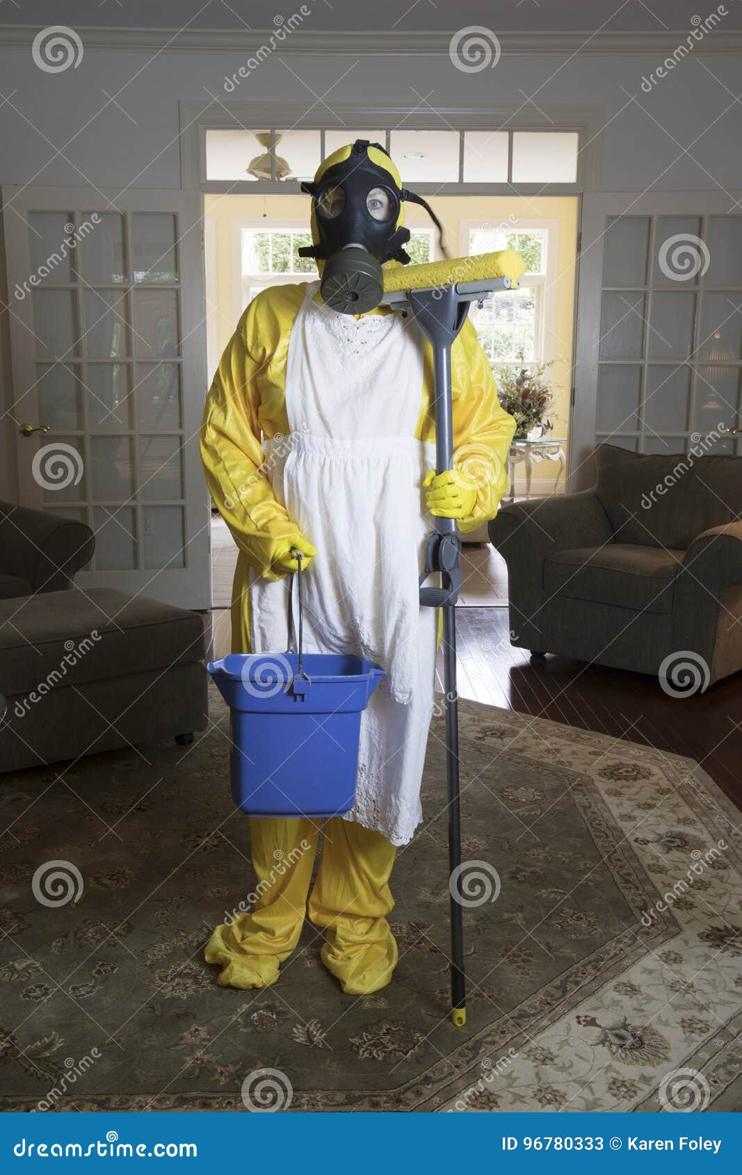 mature woman in haz mat suit with mop and bucket