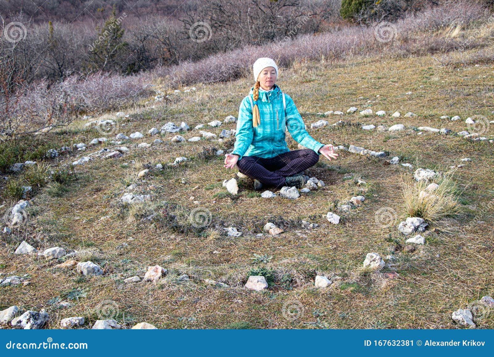 Mature Woman Practices Yoga in the Center of a Spiral Laid Out of ...