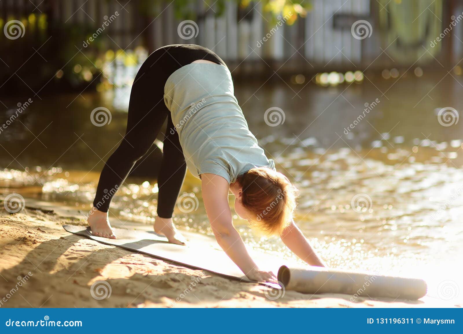 Mature Woman Practicing Yoga Outdoor Exercise On The Beach Near The River. Stock Image - Image ...