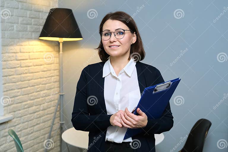 Mature Woman Psychologist Psychiatrist Social Worker With Clipboard Looking At Camera Stock