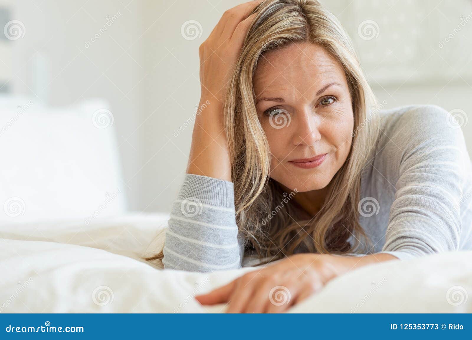 Mature Woman Relaxing On Bed Stock Image   Image of looking 