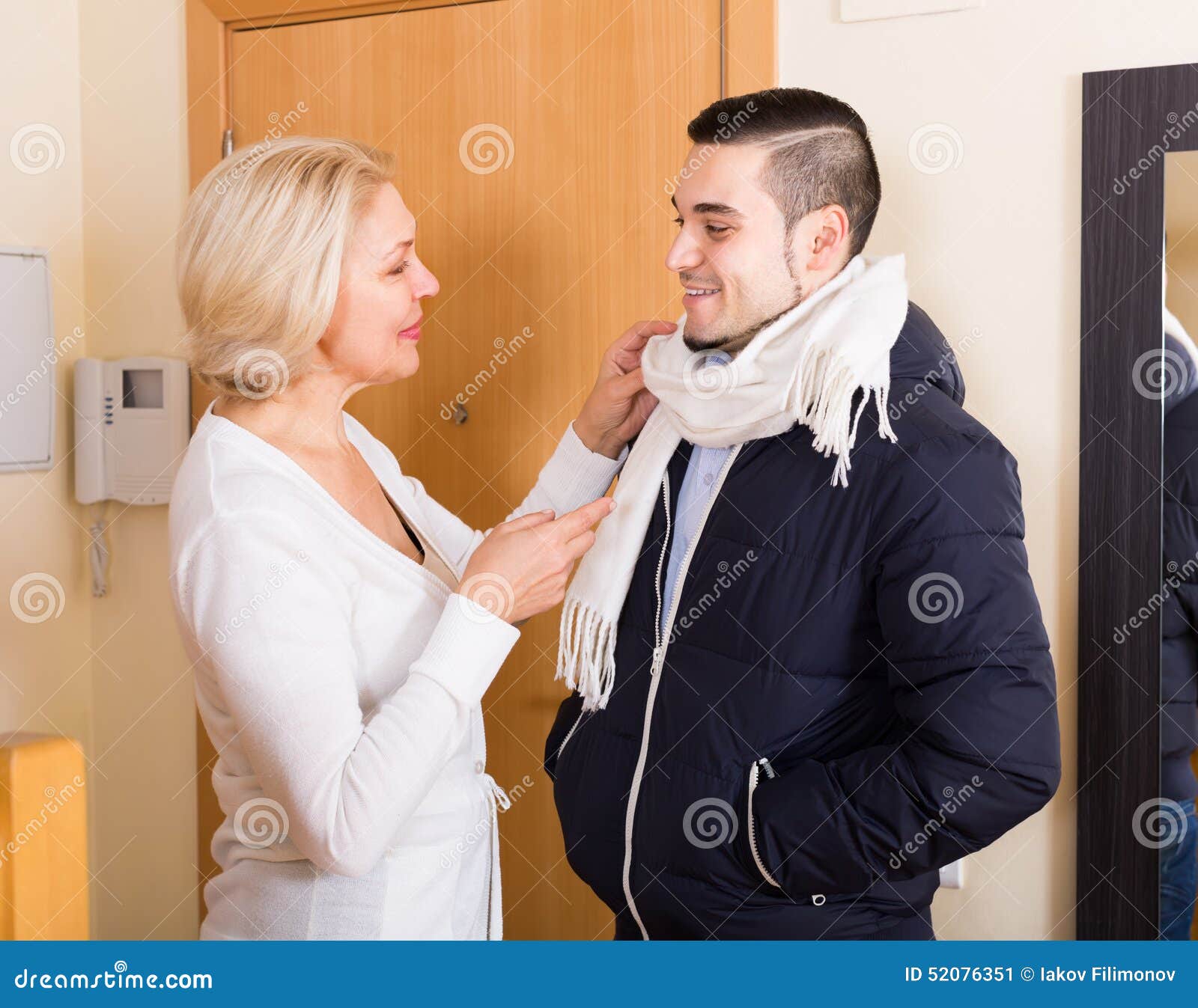 Mature Woman And Young Guy At Doorway Stock Imag