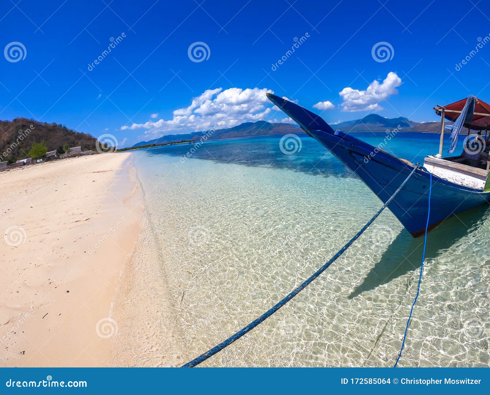 maumere - a boat anchored to a sandy beach