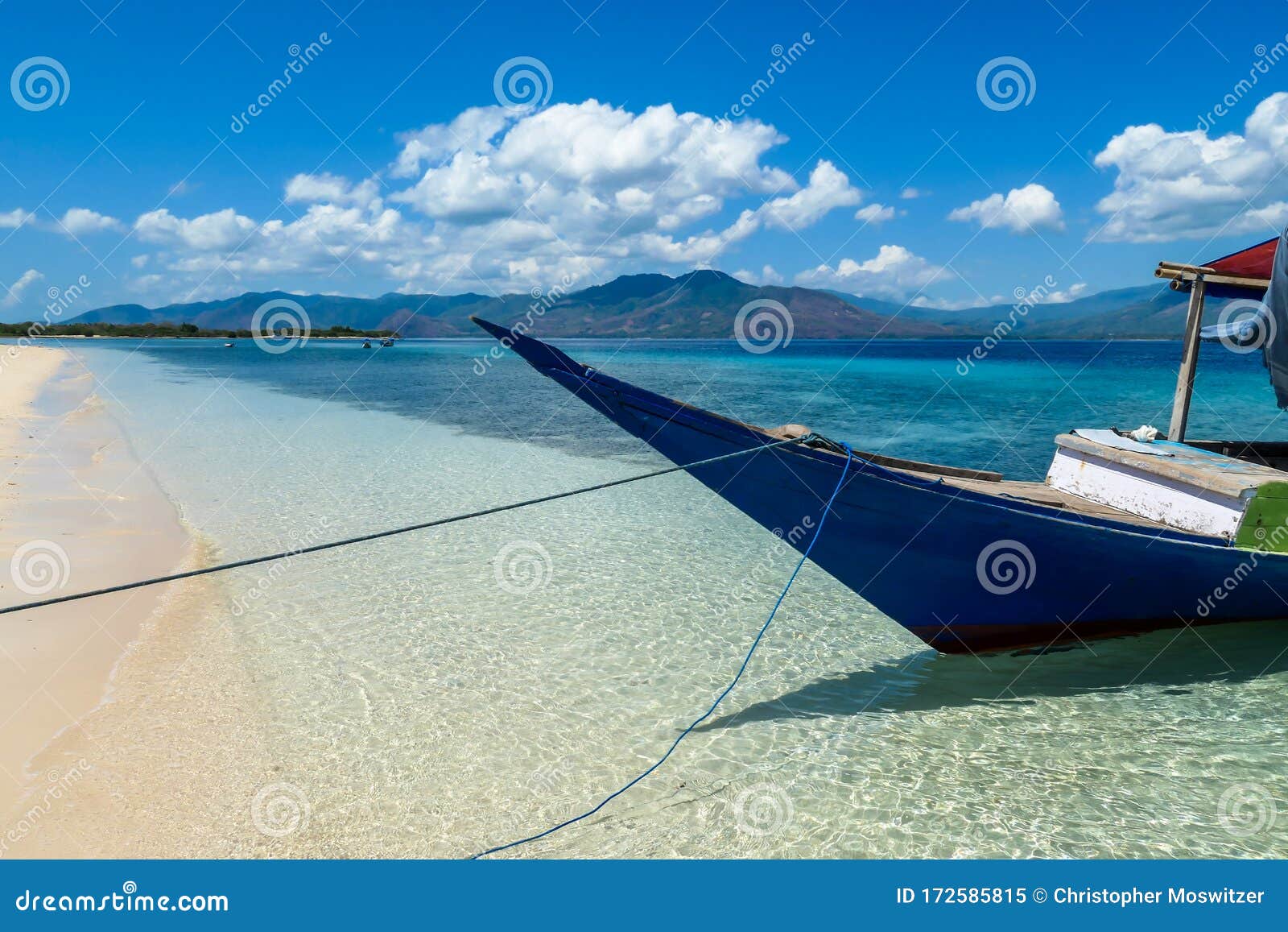 maumere - a boat anchored to a sandy beach