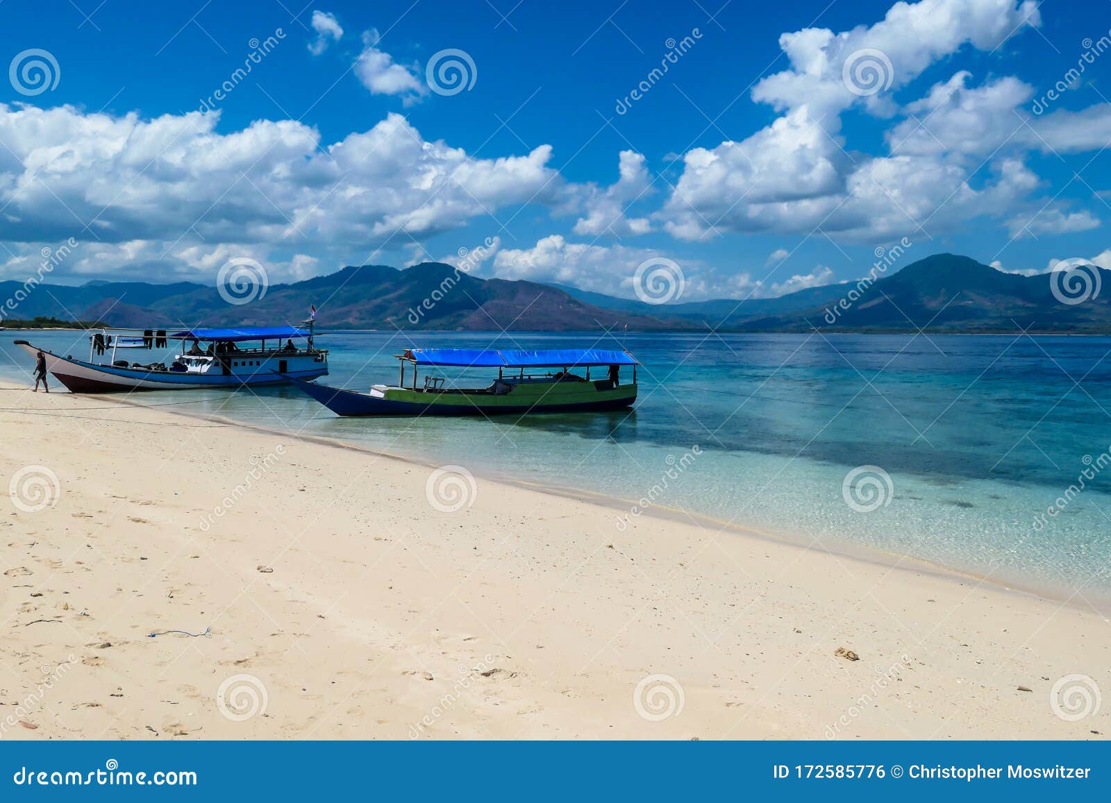 maumere - an idyllic beach with boats anchored on the shore