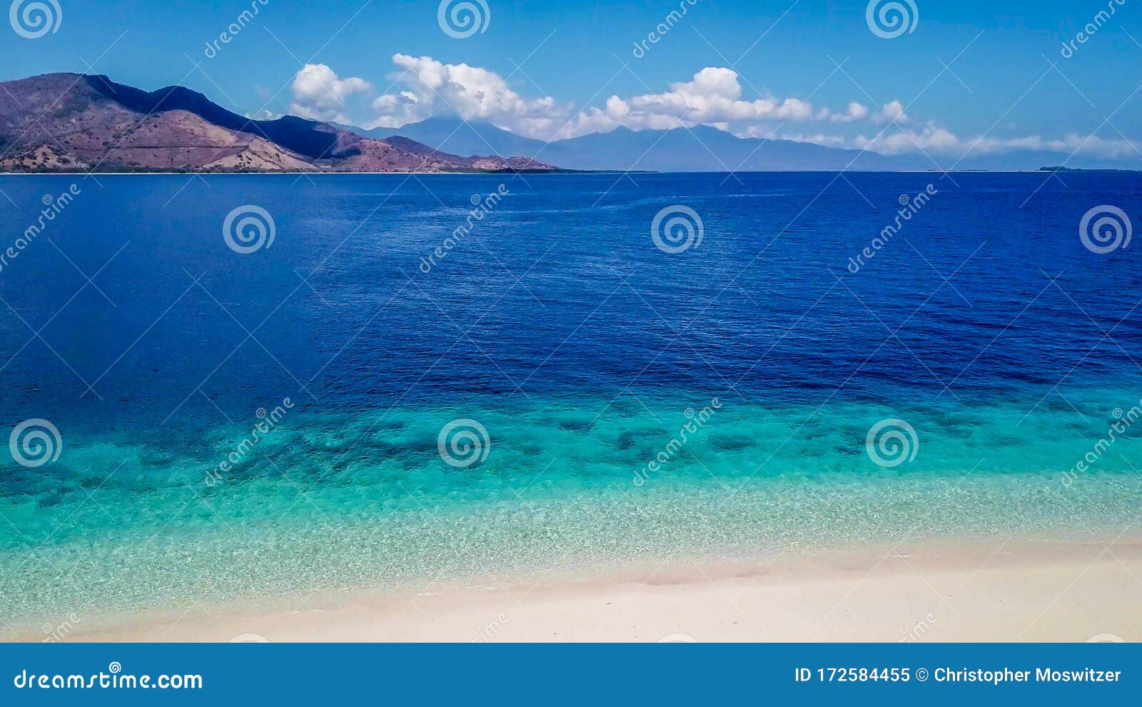 maumere - idyllic white sand beach with some other island in the back