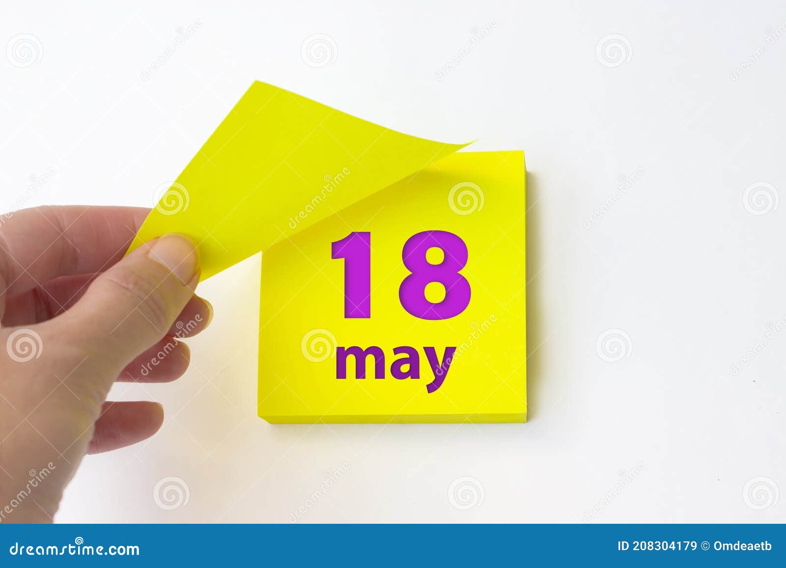 May 18th. Day 18 of Month, Calendar Date. Hand Rips Off the Yellow