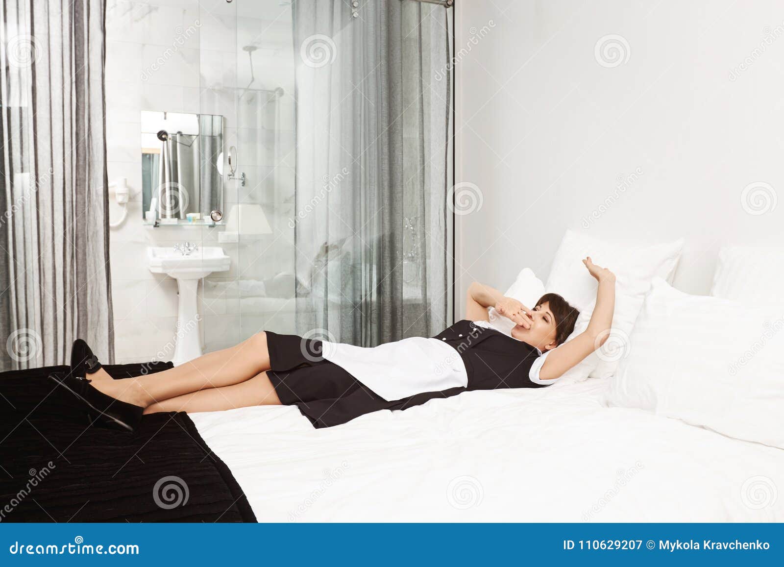 Maybe I Should Take Nap Before Clients Come Shot Of Tired Woman In Maid Uniform Lying On Bed