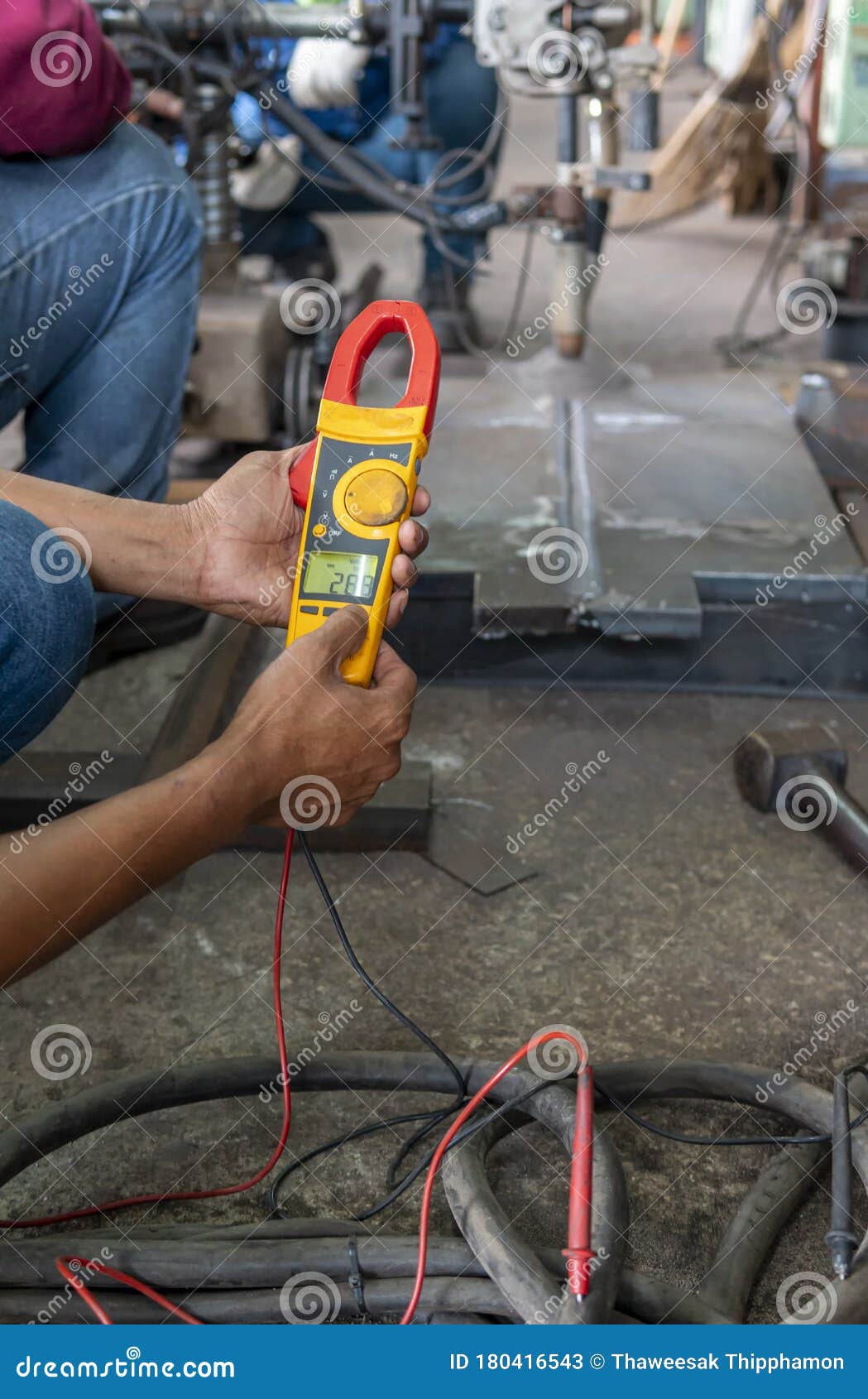 Measure Volts while Welding with Digital Clamp Meter Stock Image