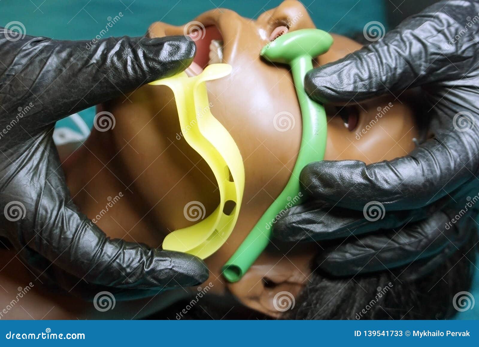 measurement of nasopharyngeal and oropharyngeal airway tubes by stuff in a black gloves on a simulation mannequin dummy during