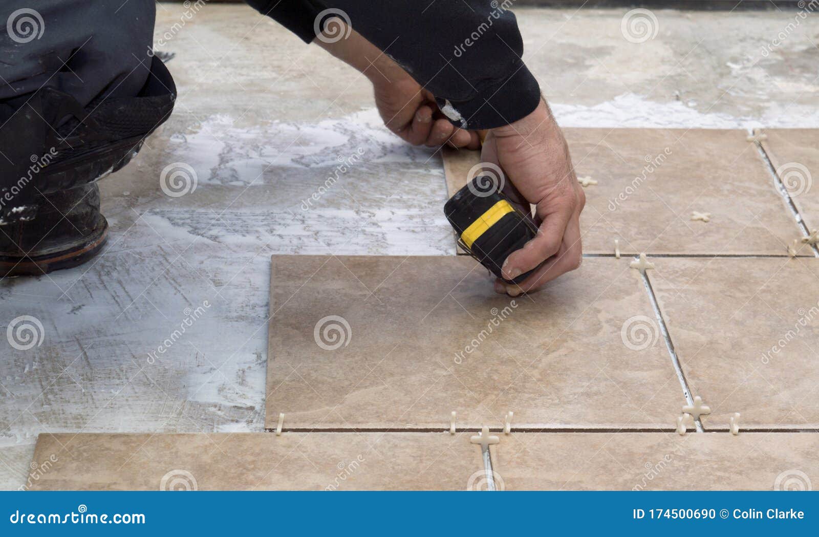 Measuring a Ceramic Tile As he Prepares To Install Them Stock Photo